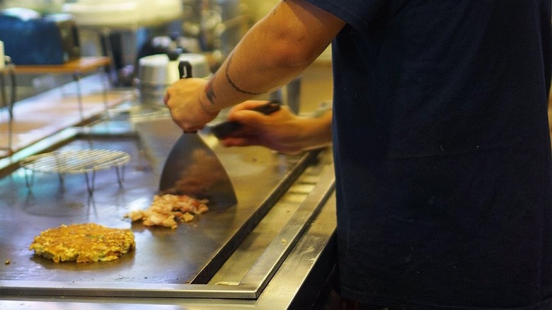 A chef cooking on a hibachi grill