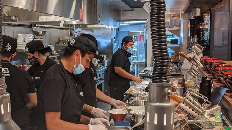 Chefs preparing ramen behind the bar, a close-up look