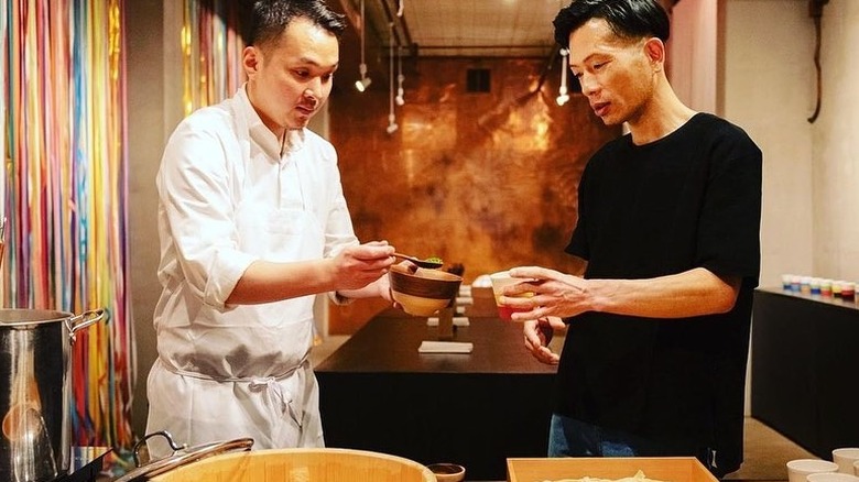 Hiroko Odo preparing a meal in porcelain cups for a guest