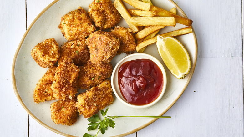 ketchup with chicken nuggets and fries