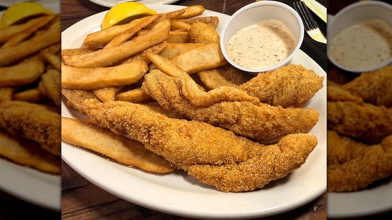 Catfish with fries on plate