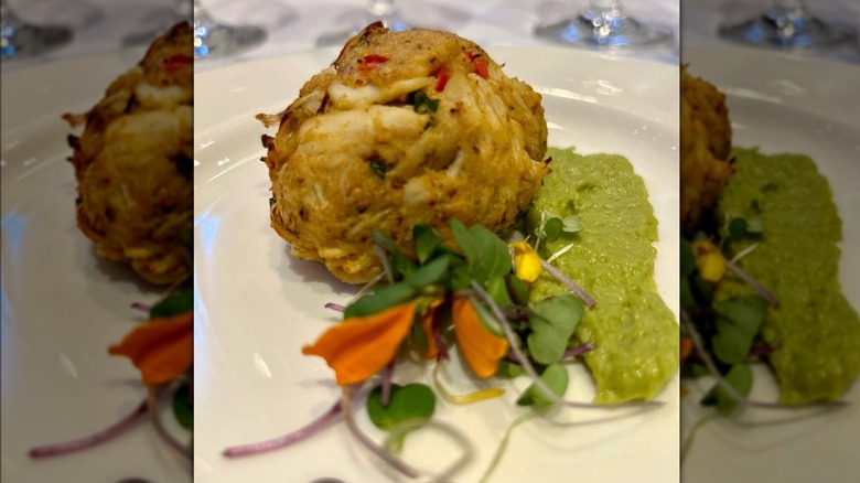 Garnished crab cake on plate