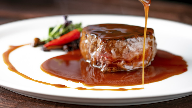 Demi-glace poured on a steak