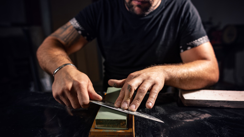 Man using a sharpening stone 