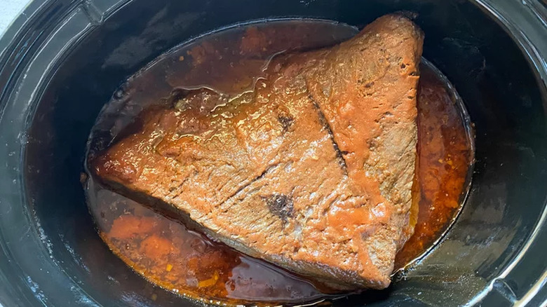 Sliced beef brisket with deeply browned exterior.