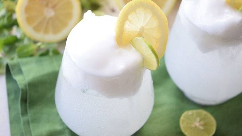 A glass of lemon lime soda with white vanilla ice cream snow white float