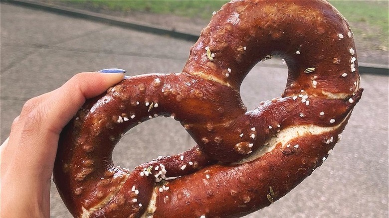 Hand holding soft pretzel