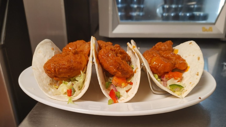 Fried buffalo shrimp tacos on a plate