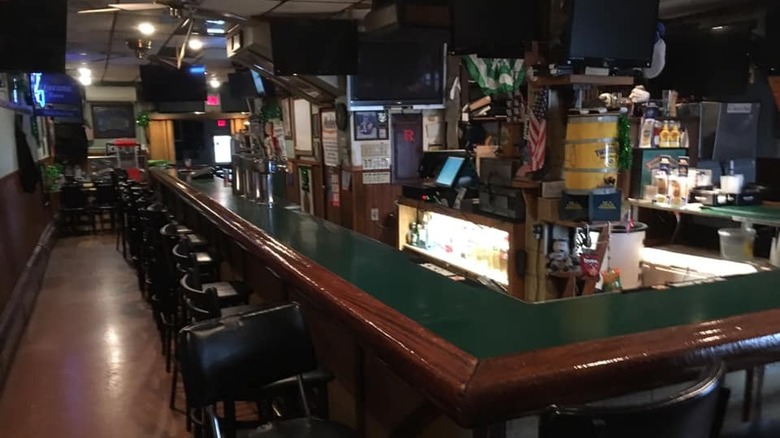 Bar counter with televisions mounted on the wall