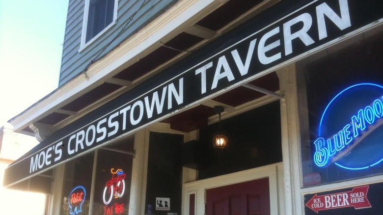 Building with a sign that says "Moe's Crosstown Tavern."