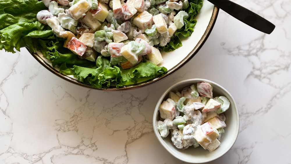 Bowl of waldorf salad with lettuce and spoon