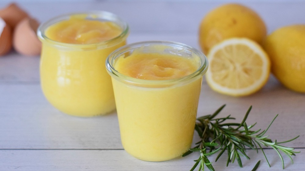 Jar of lemon curd with rosemary sprig