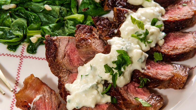 Gorgonzola blue cheese sauce on sliced steak