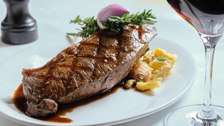 steak on a white plate with wine