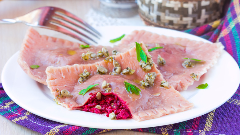 beetroot filled ravioli on white platetlo