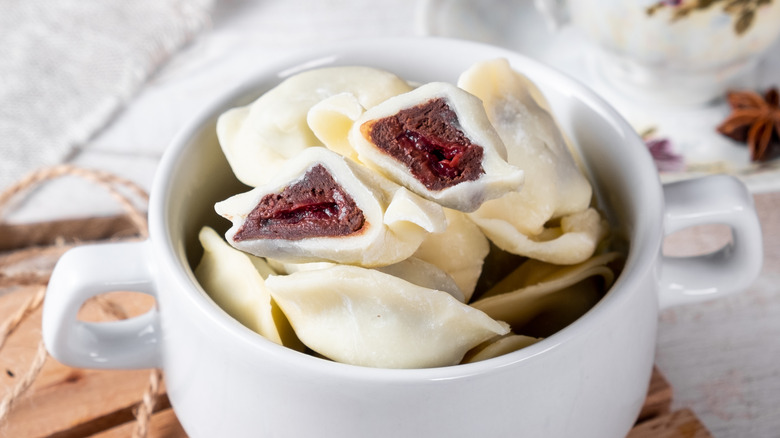 chocolate filled pasta in two-handled mug