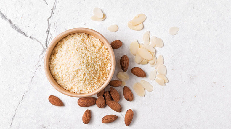 Top view of almond flour next to raw almonds 