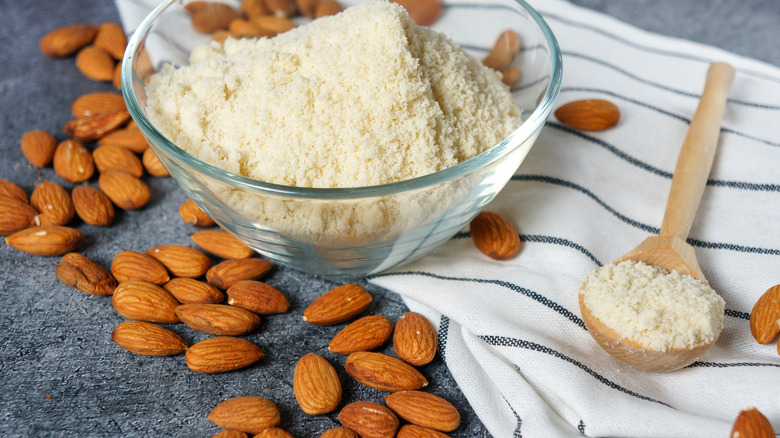 Almond flour next to whole raw almonds