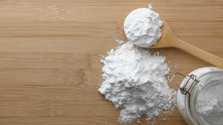 Tapioca flour on wood table next to wood spoon