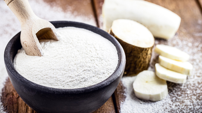 Cassava flour with scooper on wood table