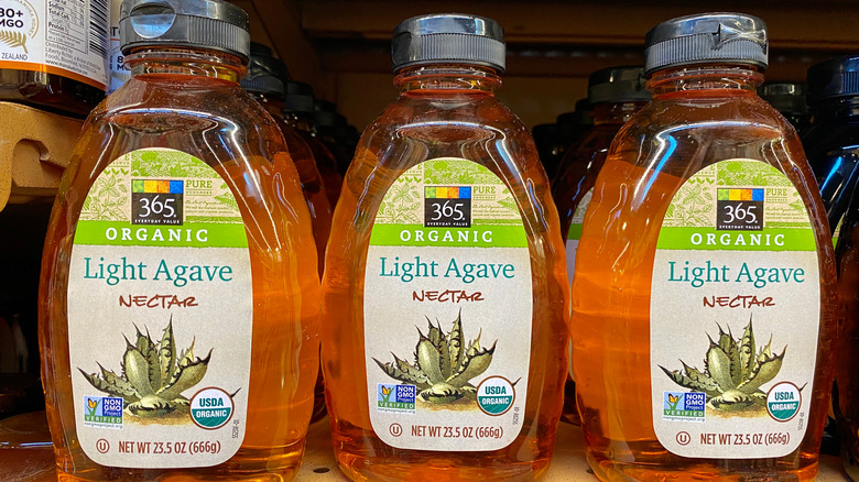 Bottles of agave nectar on store shelf