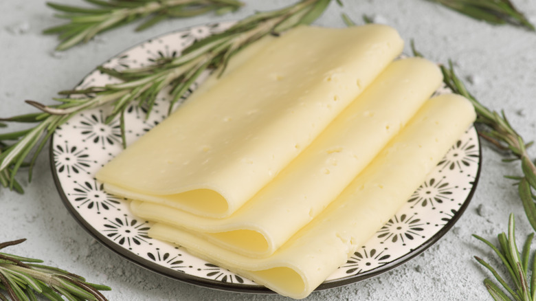 Thin slices of Havarti cheese on decorative plate