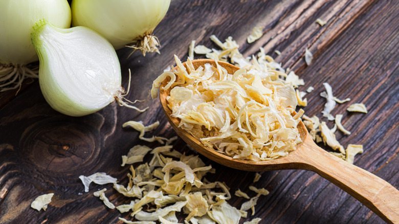 Onion flakes in a wooden spoon