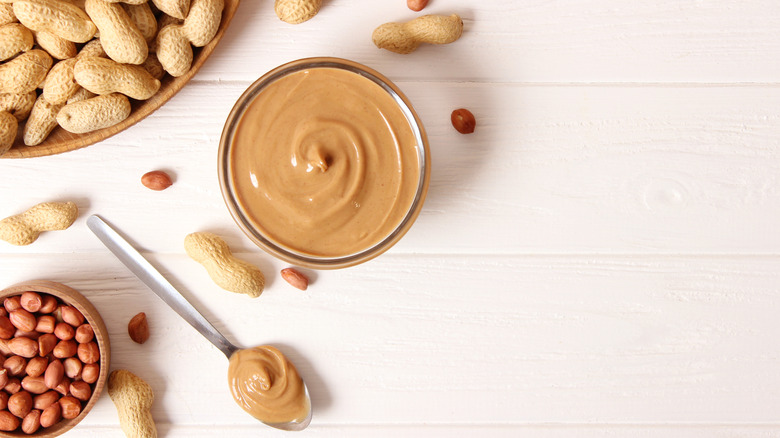 Top view of peanut butter jar next to spoon