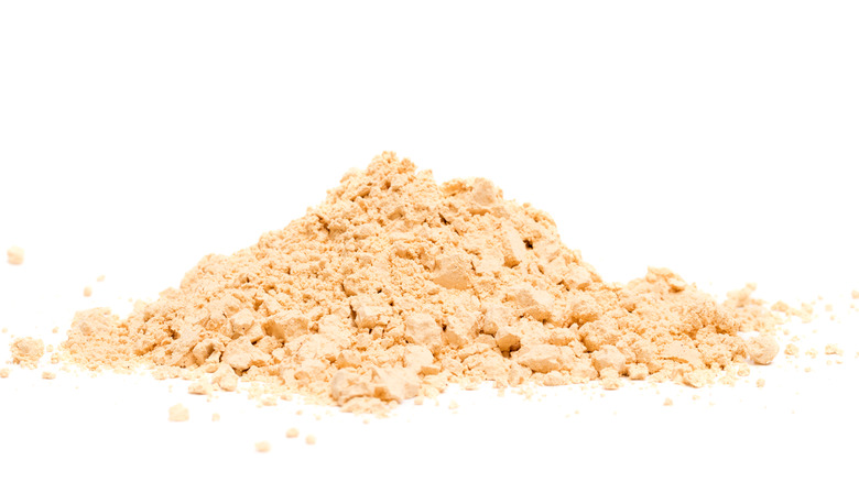 Peanut butter powder on white background