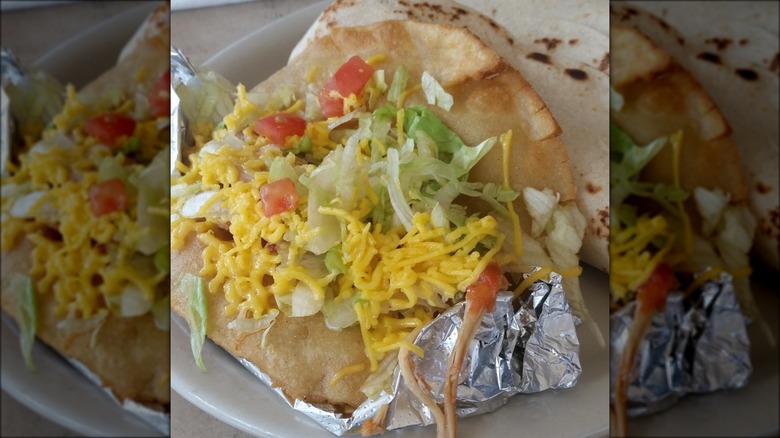 Chicken puffy taco served in foil