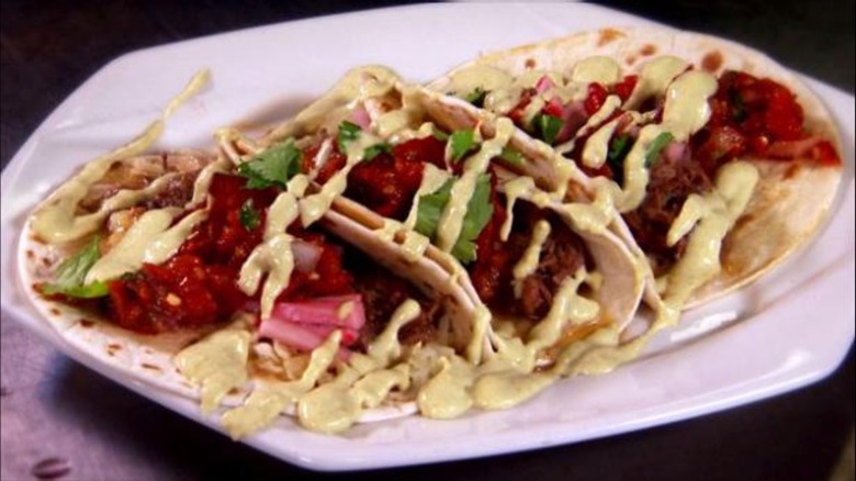 Trio of tasso tacos on white plate