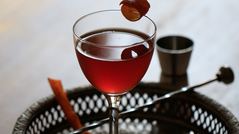 Red Rosita cocktail in glass with stirrer