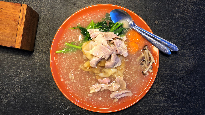 bowl of flat noodles with pork
