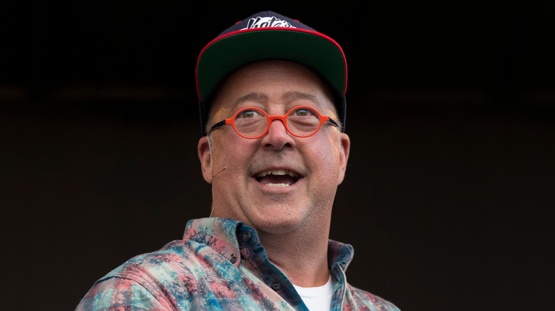 Andrew Zimmern on a black background