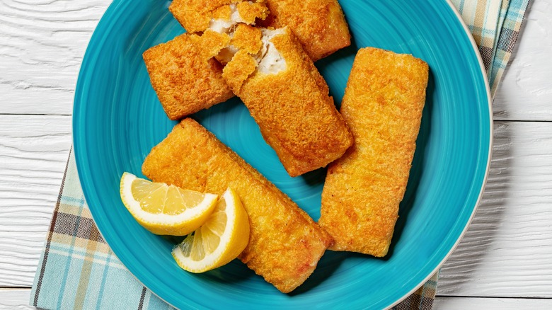 fried pollock fillets on blue plate