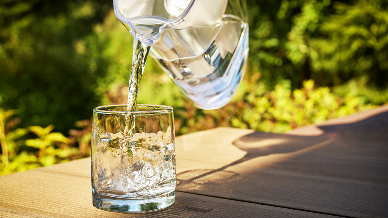 Pouring from water filter pitcher