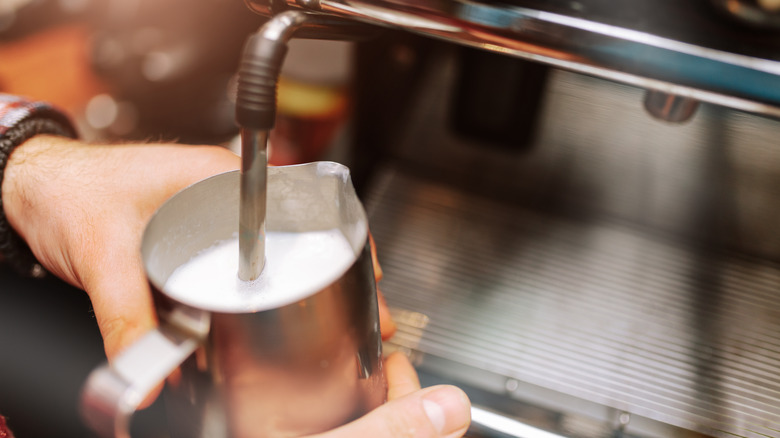 Person using milk frother