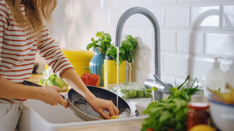 A woman cleaning a nonstick pan