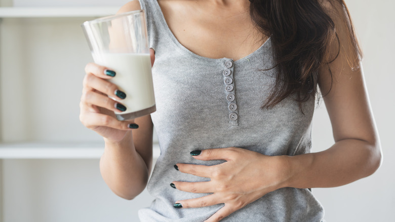 Person holding glass of milk