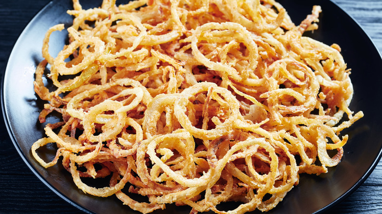 crispy onions on black plate