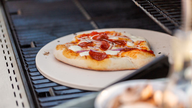 A pizza slice on a gas grill