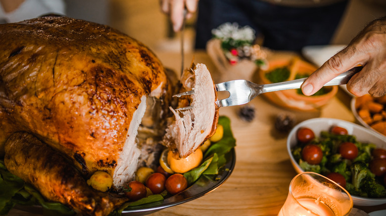 Person holding fork filled with Thanksgiving turkey