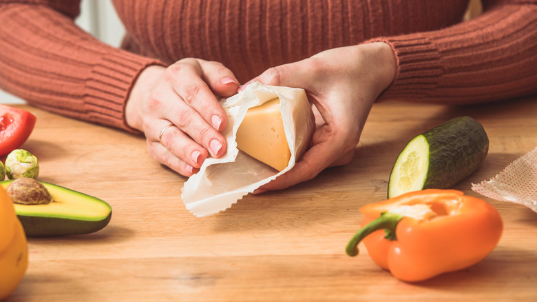 Woman wrapping cheese