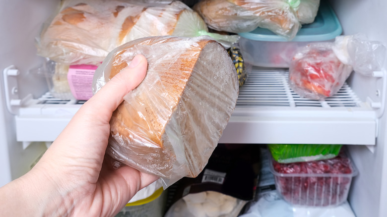 Putting wrapped bread in freezer