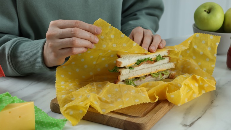 Person wrapping sandwich