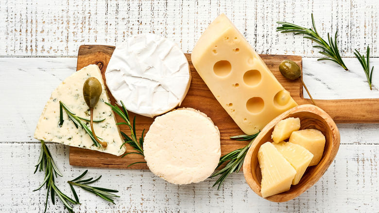Cutting board with various types of cheese