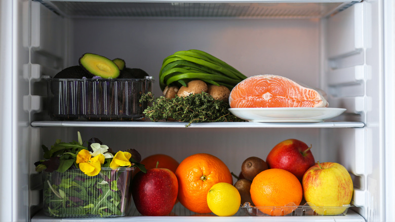 Fridge full of produce and raw fish