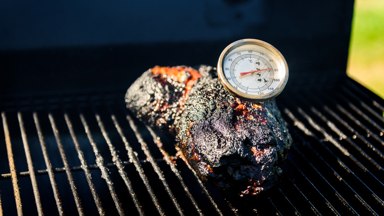 beef on grill with thermometer