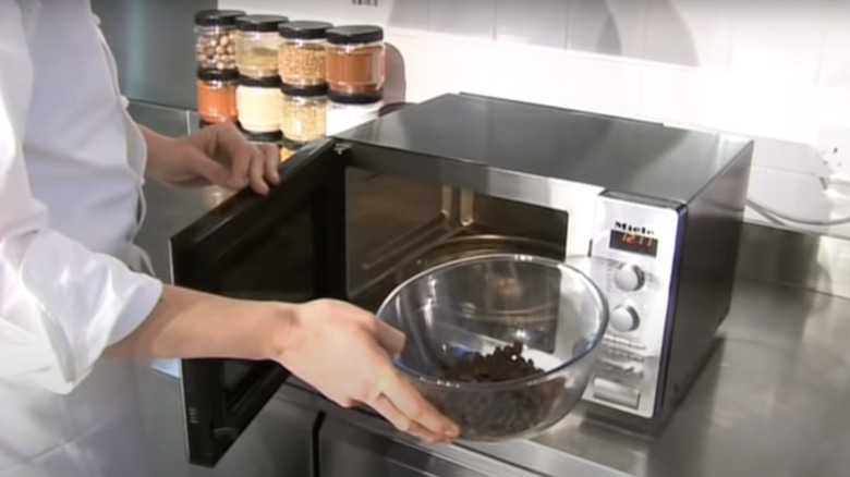 Man melting chocolate in microwave