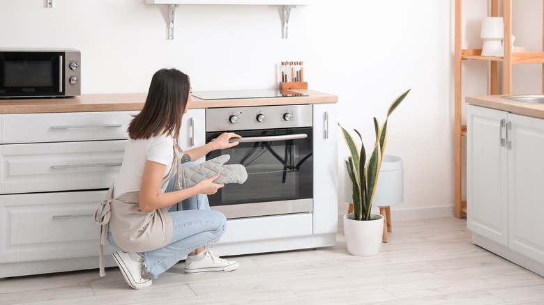 Woman opening an oven